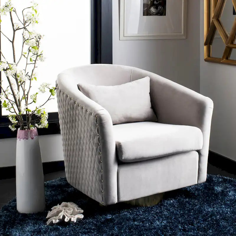 Fauteuil baignoire pivotant en velours vieux rose, capitonnage à losanges, garniture cloutée, piètement pivotant doré