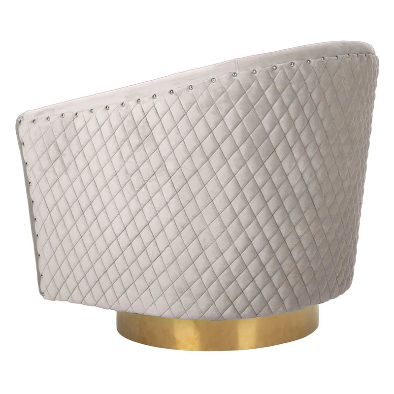 Fauteuil baignoire pivotant en velours vieux rose, capitonnage à losanges, garniture cloutée, piètement pivotant doré